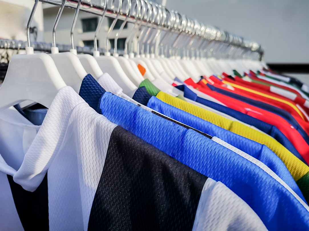 Clean sports jerseys hanging on a rack